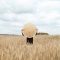 Artistic scene in a wheat field with a mirror reflecting the field. Shot outdoors with natural light.